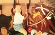 Julie Books Riding Carousel Horse as a Child